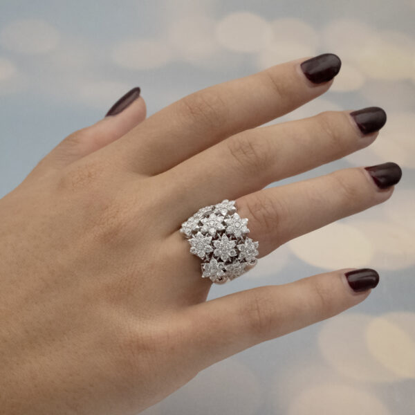 diamond-floral-mesh-ring-on-finger-claris-a.jpg Diamond floral mesh ring in 18K white gold with individually mounted diamond flowers and heart-shaped cut-outs by Claris-A.