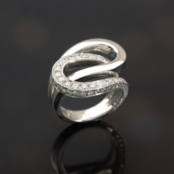 interwoven-diamond-loop-ring-claris-a.jpg Interwoven diamond loop ring in 18K white gold with one polished band and one pavé-set with brilliant-cut diamonds by Claris-A.