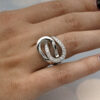 4542 Interwoven diamond loop ring in 18K white gold with one polished band and one pavé-set with brilliant-cut diamonds by Claris-A.