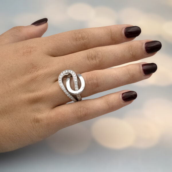 interwoven-diamond-loop-ring-claris-a.jpg Interwoven diamond loop ring in 18K white gold with one polished band and one pavé-set with brilliant-cut diamonds by Claris-A.