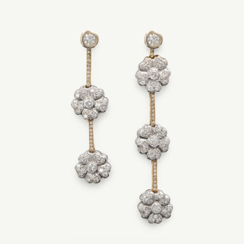 Diamond floral drop earrings in 18K white and yellow gold with asymmetric flower clusters and slender connecting lines by Claris-A.