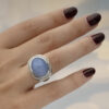 Chalcedony and diamond ring in 18K white gold with a domed lavender-blue chalcedony cabochon framed by brilliant-cut diamonds by Claris-A.