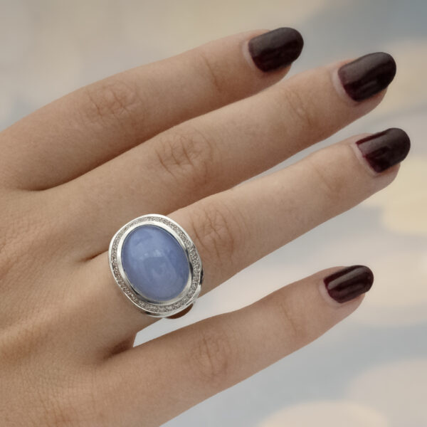 Chalcedony and diamond ring in 18K white gold with a domed lavender-blue chalcedony cabochon framed by brilliant-cut diamonds by Claris-A.