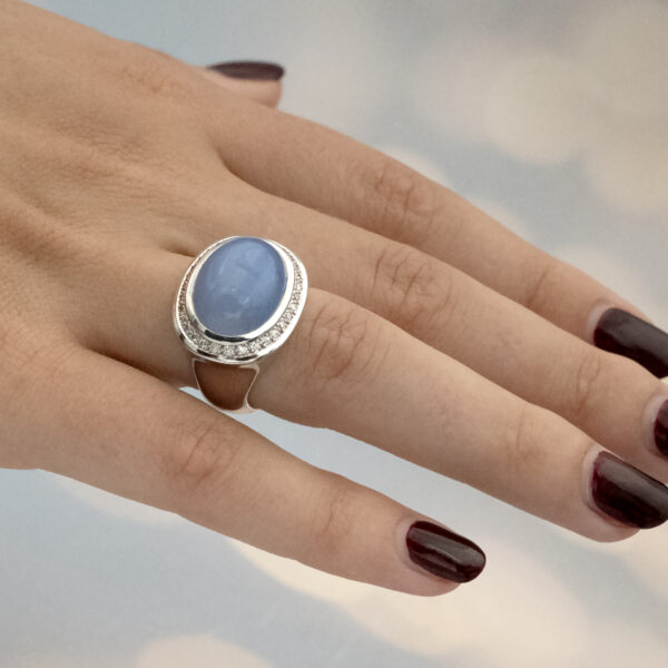 Chalcedony and diamond ring in 18K white gold with a domed lavender-blue chalcedony cabochon framed by brilliant-cut diamonds by Claris-A.