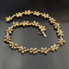 gold-diamond-floral-necklace-claris-a.jpg Gold and diamond floral necklace in 18K yellow gold with hammered petals, polished links, and alternating diamond-set and plain flowers by Claris-A.