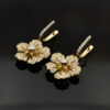 diamond-18Kgold-earrings-claris-a.jpg Diamond floral earrings in 18K yellow gold with softly curved petals, a central diamond, and diamond-set hoops by Claris-A.