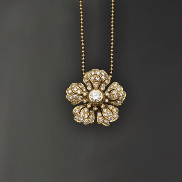 diamond-flower-pendant-necklace-claris-a.jpg Diamond flower pendant necklace in 18K yellow gold with pavé-set petals and a bezel-set center diamond by Claris-A.