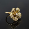 Diamond flower ring in 18K yellow gold with individually shaped diamond-set petals and a 0.15 ct center diamond by Claris-A.