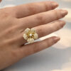 Diamond flower ring in 18K yellow gold with individually shaped diamond-set petals and a 0.15 ct center diamond by Claris-A.