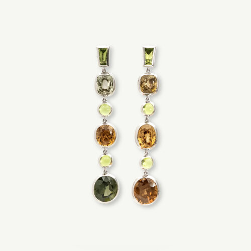 zircon-peridot-dangle-earrings-claris-a.jpg White gold earrings with alternating natural zircons and peridots arranged in a long articulated line for fluid movement.