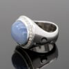 Chalcedony and diamond ring in 18K white gold with a domed lavender-blue chalcedony cabochon framed by brilliant-cut diamonds by Claris-A.