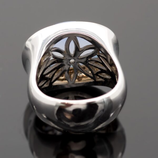 Chalcedony and diamond ring in 18K white gold with a domed lavender-blue chalcedony cabochon framed by brilliant-cut diamonds by Claris-A.