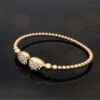 diamond-cuff-bracelet-18k-rose-gold.jpg 18K rose gold diamond cuff bracelet with articulated bead structure and teardrop diamond caps