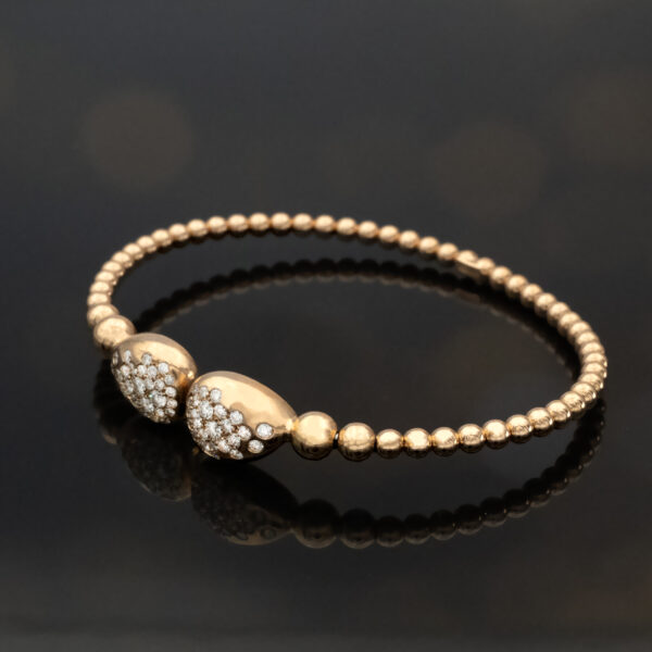 diamond-cuff-bracelet-18k-rose-gold.jpg 18K rose gold diamond cuff bracelet with articulated bead structure and teardrop diamond caps