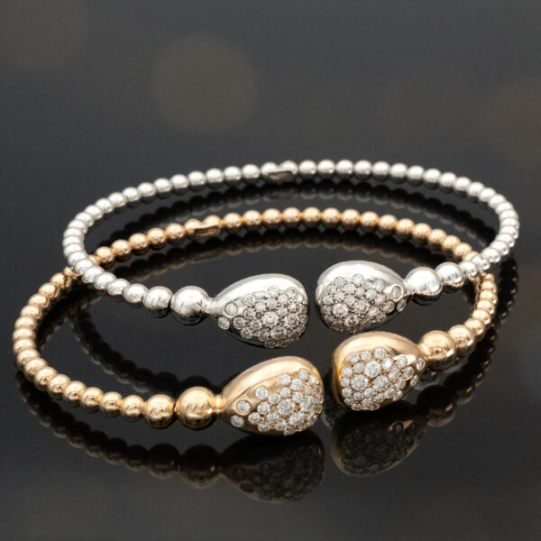 clarisa-diamond-cuff-bracelet-18k-rose-gold.jpg 18K rose gold diamond cuff bracelet with articulated bead structure and teardrop diamond caps