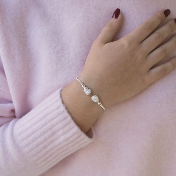 diamond-cuff-bracelet-18k-white-gold.jpg 18K white gold diamond cuff bracelet with articulated bead structure and teardrop diamond caps