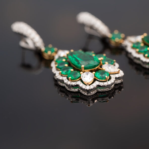 Muzo green Colombian emerald diamond earrings in 18K white gold with pear-shaped emeralds framed by emeralds and diamonds
