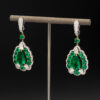 muzo-green-colombian-emerald-diamond-earrings-white-gold.jpg Muzo green Colombian emerald diamond earrings in 18K white gold with pear-shaped emeralds framed by emeralds and diamonds