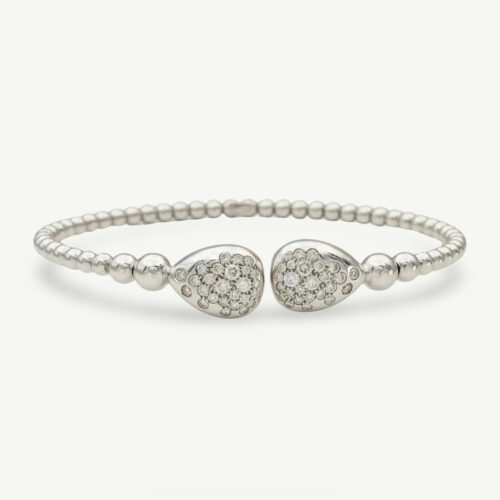 diamond-cuff-bracelet-18k-white-gold.jpg 18K white gold diamond cuff bracelet with articulated bead structure and teardrop diamond caps