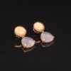 rose-quartz-prism-drop-earrings.jpg Rose gold earrings with a softly translucent triangular rose quartz cabochon drop, featuring a rounded element at the ear and smooth mounts.