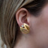 hammered-gold-leaf-diamond-earrings.jpg Hammered yellow gold leaf earrings with an open tip design, each set with a single diamond suspended between the curved terminals.