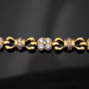 Diamond Floral Link Bracelet in 18K Yellow Gold Articulated 18K yellow gold bracelet with rounded links and raised floral motifs set with diamonds, forming a fluid, polished design.