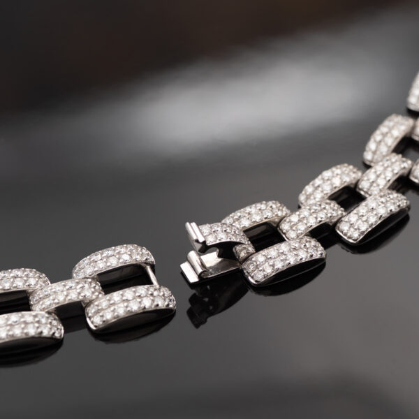 Articulated 18K white gold necklace composed of rectangular diamond-set links with open centres and a structured, graphic design.