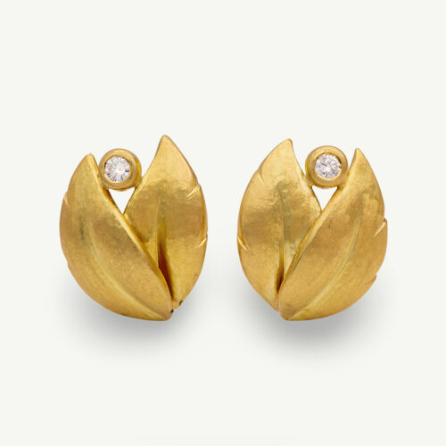 hammered-gold-leaf-diamond-earrings.jpg Hammered yellow gold leaf earrings with an open tip design, each set with a single diamond suspended between the curved terminals.