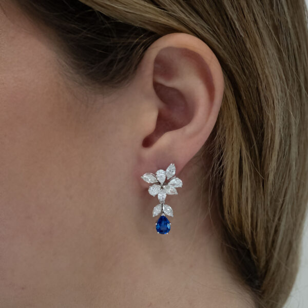 Sapphire-earrings-on-ear Sapphire and Diamond Claris-A Drop earrings on ear.