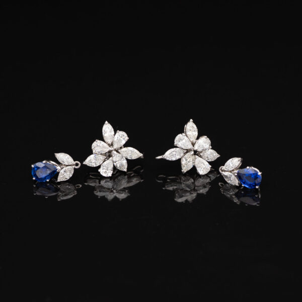 Sapphire and Diamond Earrings laying in black tile