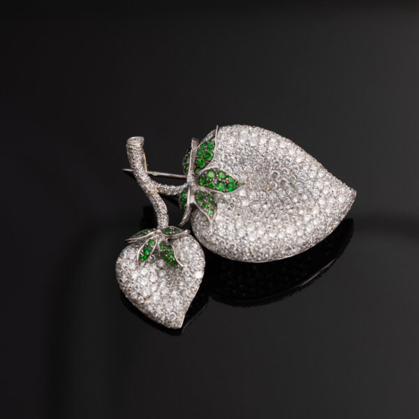 diamond-pave-leaf-pendant-tsavorite-detail Detail of pavé-set diamonds and tsavorite branch on leaf pendant