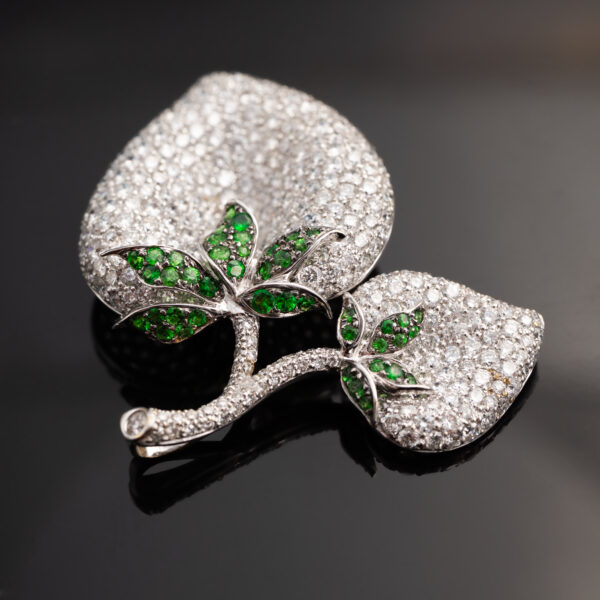 diamond-pave-leaf-pendant-tsavorite-detail Detail of pavé-set diamonds and tsavorite branch on leaf pendant