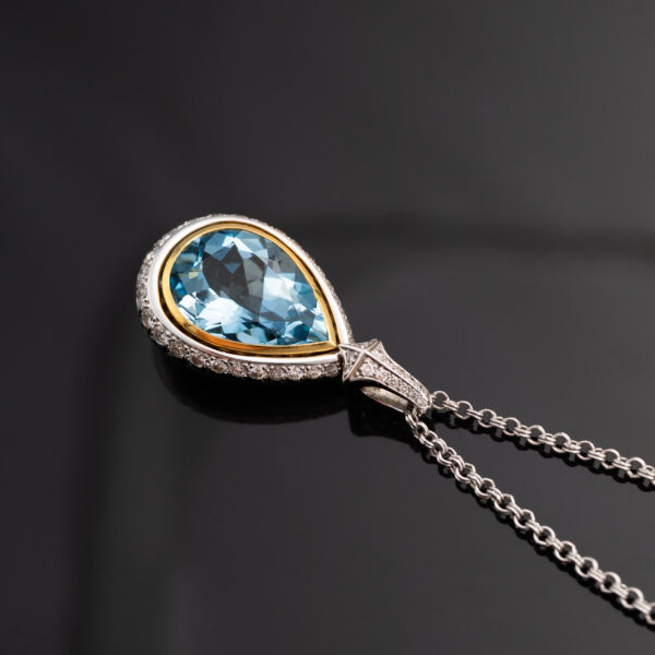 Aquamarine Diamond Halo Pendant White Yellow Gold White and yellow gold pendant with pear-shaped aquamarine and diamond halo