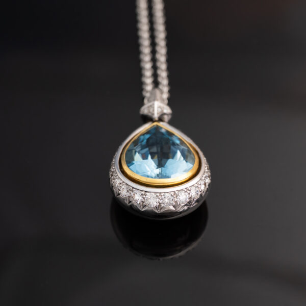 Aquamarine Diamond Halo Pendant White Yellow Gold White and yellow gold pendant with pear-shaped aquamarine and diamond halo