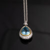 Aquamarine Diamond Halo Pendant White Yellow Gold White and yellow gold pendant with pear-shaped aquamarine and diamond halo