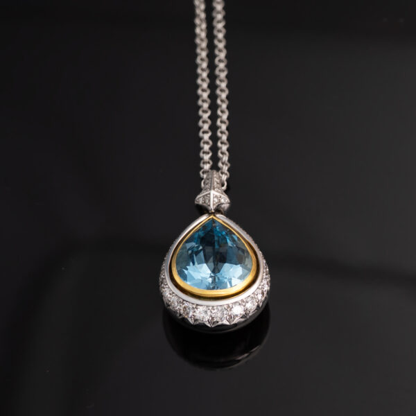 White and yellow gold pendant with pear-shaped aquamarine and diamond halo