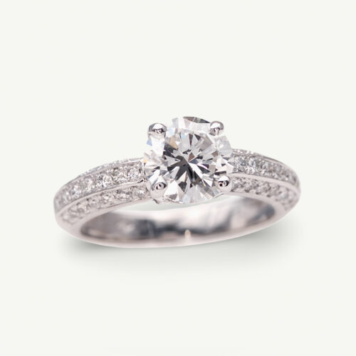 Cover_ClarisA_Ring 18K white gold diamond engagement ring with a 1.50ct round brilliant centre stone in a four-prong setting and pavé-set diamond