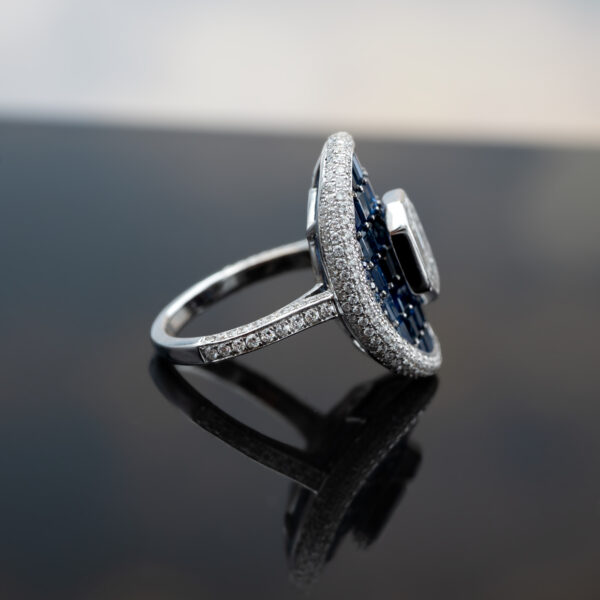 Sapphire Diamond Illusion Cluster Ring 18K white gold ring with illusion-set diamond cluster centre surrounded by baguette sapphires and pavé diamonds