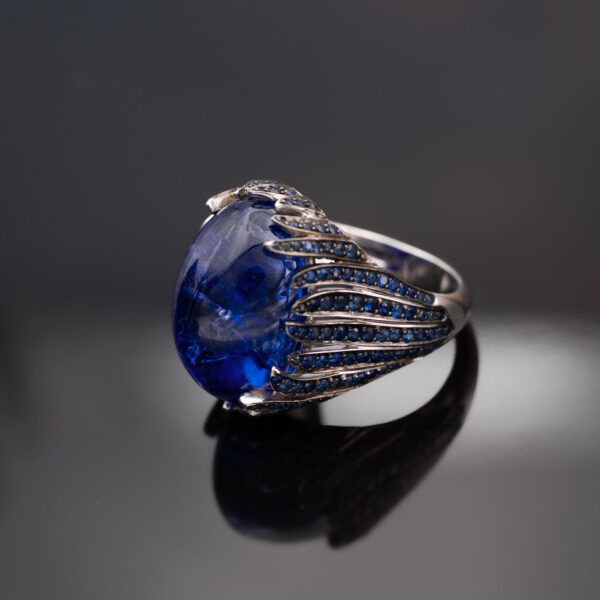 Tanzanite Cabochon Sculptural Ring tanzanite cabochon and sapphire ring in white gold with sculptural curved design