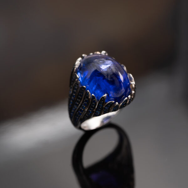 Tanzanite Cabochon Sculptural Ring tanzanite cabochon and sapphire ring in white gold with sculptural curved design