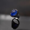 Tanzanite Cabochon Sculptural Ring tanzanite cabochon and sapphire ring in white gold with sculptural curved design