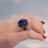 Tanzanite Cabochon Sculptural Ring tanzanite cabochon and sapphire ring in white gold with sculptural curved design