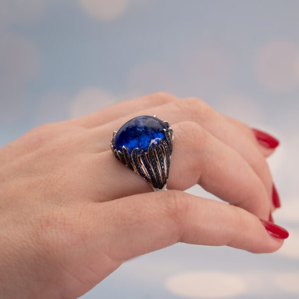 tanzanite cabochon and sapphire ring in white gold with sculptural curved design