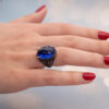 Tanzanite Cabochon Sculptural Ring tanzanite cabochon and sapphire ring in white gold with sculptural curved design