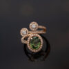ClarisA_Gold_Ring_18K 18K rose gold openwork ring with oval green sapphire and diamond halo, sculptural asymmetrical wrap design