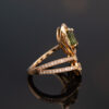 Ring_RoseGold_SideView 18K rose gold openwork ring with oval green sapphire and diamond halo, sculptural asymmetrical wrap design