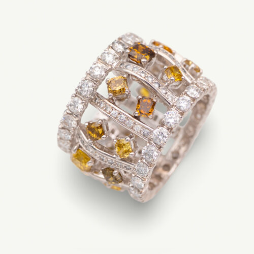 Cover_ClarisA Wide 18K white gold ring with structured diamond-set bars and rows of white and fancy colored diamonds around the band
