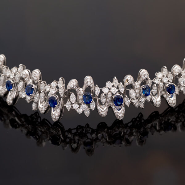 Sapphire Diamond Bracelet White Gold White gold bracelet with oval blue sapphires and diamond-set articulated links in a sculptural design