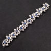 Sapphire Diamond Bracelet White Gold White gold bracelet with oval blue sapphires and diamond-set articulated links in a sculptural design