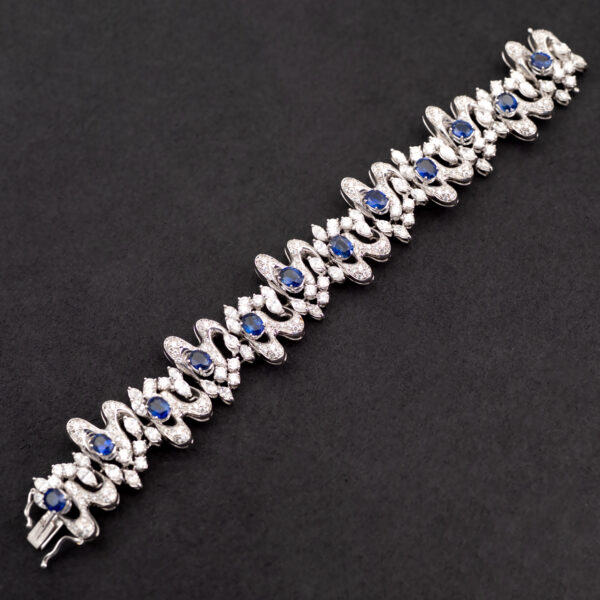 Sapphire Diamond Bracelet White Gold White gold bracelet with oval blue sapphires and diamond-set articulated links in a sculptural design